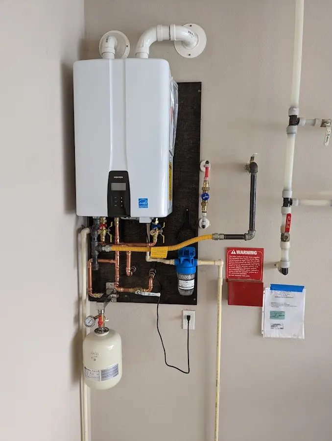 Professional plumber installing copper piping in a Timberwood Park home